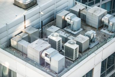 Looking down onto commercial building at large air conditioning units