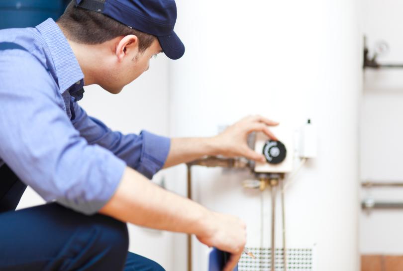 plumber working on hot water system 