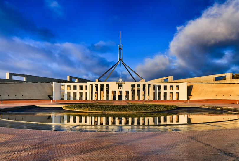 A photo of Australian Government Parliament house lit by the morning sun