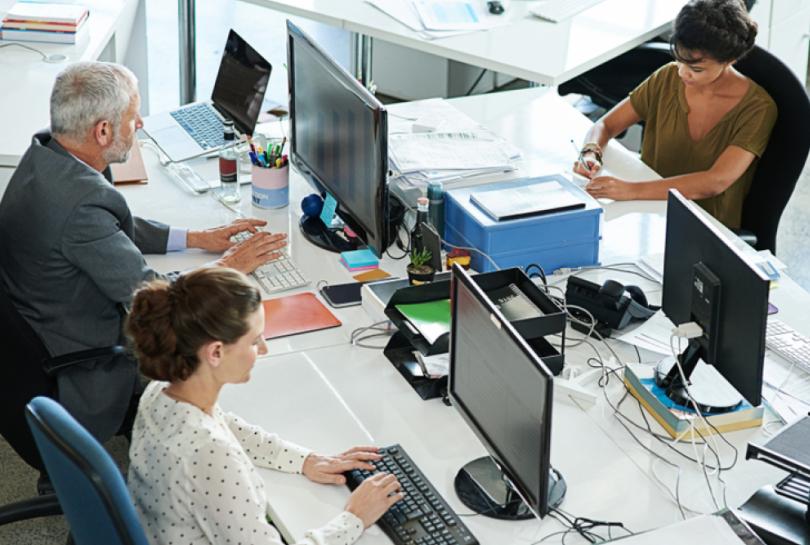 Colleagues working at their desks